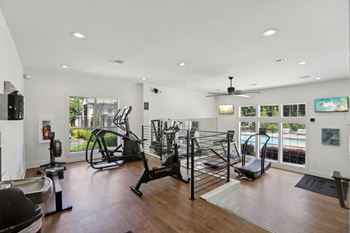 A spacious home gym with a variety of exercise equipment.